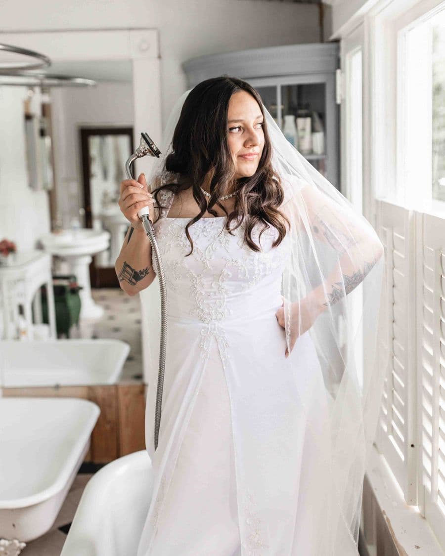 Bride getting ready in natural window light — light and airy wedding photographer